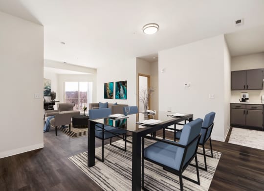 a dining area with a table and chairs and a kitchen in the background.at Shoreline Village, Washington