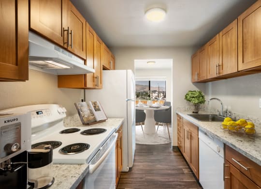 a kitchen with white appliances and wooden cabinets at Cedarwood, Wenatchee, WA