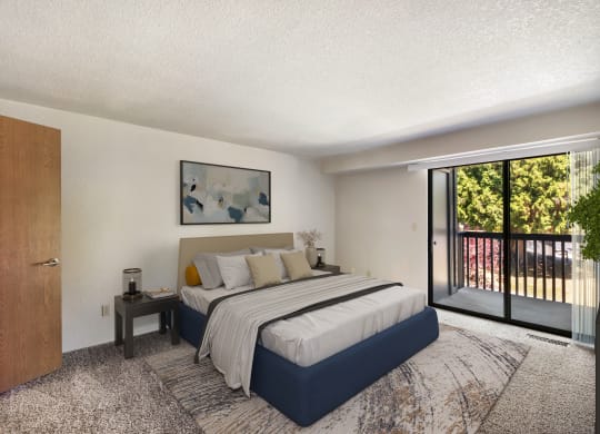 a bedroom with a bed and a sliding glass door at Cedarwood, Wenatchee, WA