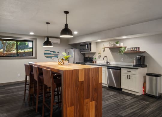 a kitchen with white cabinets and a wooden island with a wooden countertopat Cedarwood, Wenatchee, WA