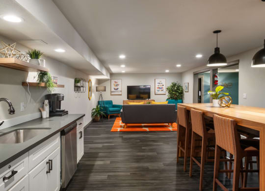 a kitchen with white cabinets and a wooden counter top next to a living room with a couch at Cedarwood, Wenatchee, WA 98801