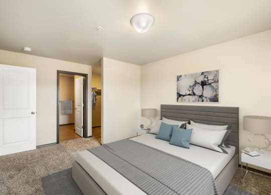 a bedroom with a large bed and a door to a bathroom  at Altitude, East Wenatchee, Washington