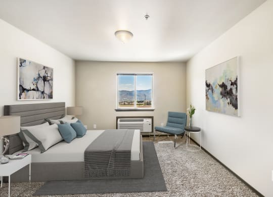 a bedroom with a bed and a chair in a 555 waverly unit  at Altitude, East Wenatchee