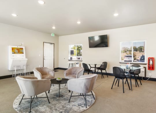 a room with chairs and a table with a television on the wall  at Altitude, East Wenatchee, WA