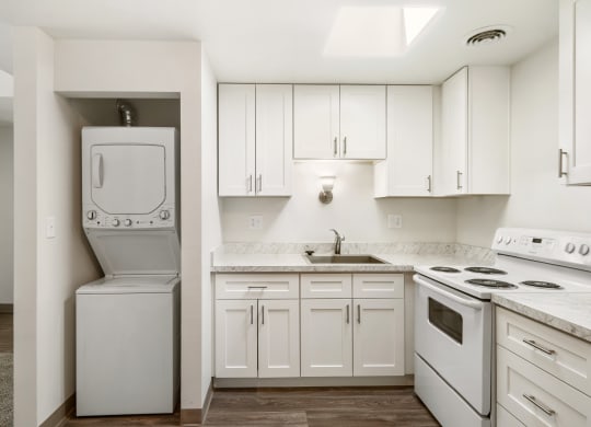 a white kitchen with white appliances and white cabinets at Park View Apartments, Wenatchee, WA