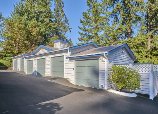 a row of garages with green doors on the side of a street at Edmonds Gateway, Edmonds, 98026