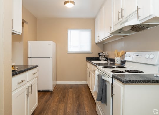 a kitchen with white appliances and white cabinets at Ella 1711 Apartments, Woodland, 95695