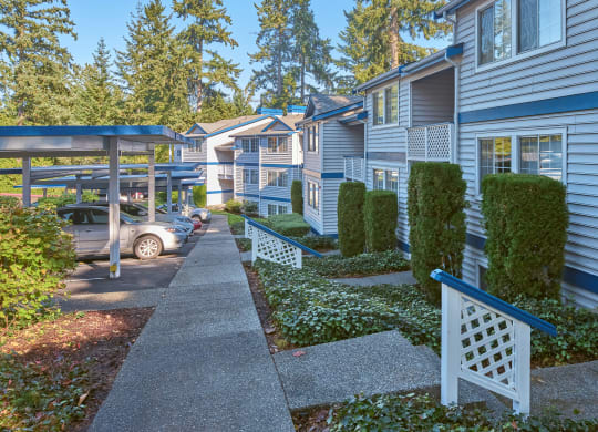 a row of townhomes with blue siding and white trim at Edmonds Gateway, Bremerton
