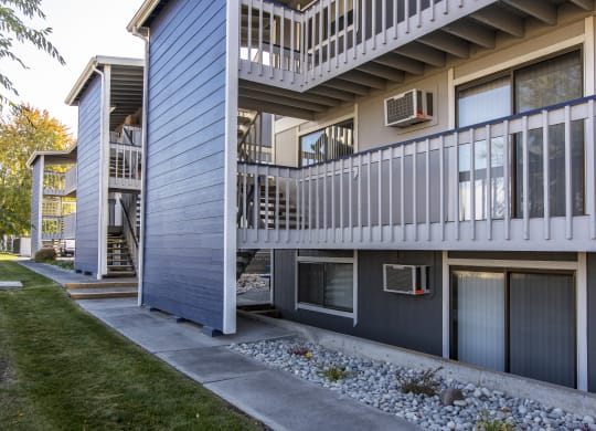 Exterior view of rock path and buildings at The Lakes Apartments, Moses Lake, WA.