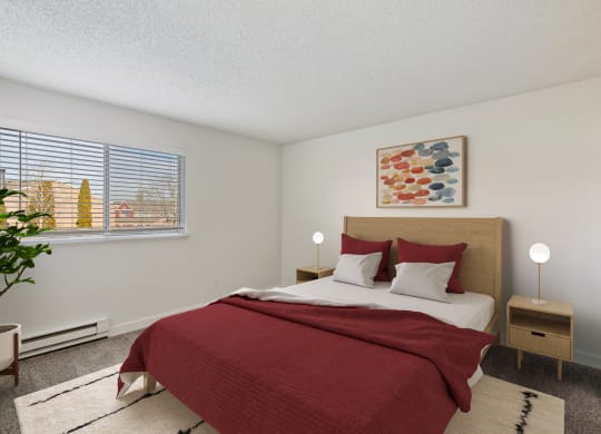Bedroom with taupe carpet, white walls, and a large window with blinds. Staged with a queen-size bed, 2 side tables, a rug, and art. at Pointe East, Washington