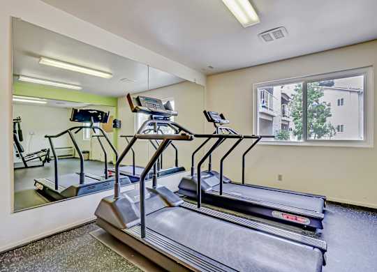 a gym with treadmills and other equipment at Gateway, Chico, California