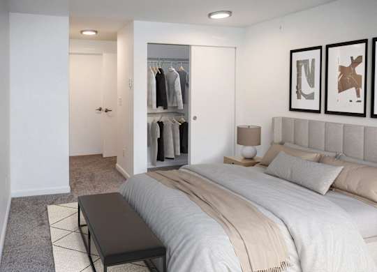 A bedroom with a large bed and a walk-in closet at Heritage Grove in Renton.