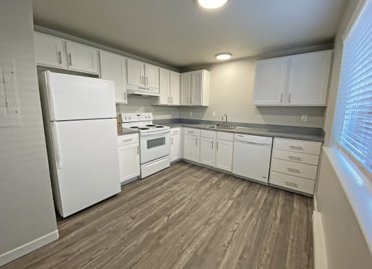 Spacious l-shaped kitchen, natural light, white appliances, top and bottom cabinet storage.at Quilceda Gardens, Marysville, 98270