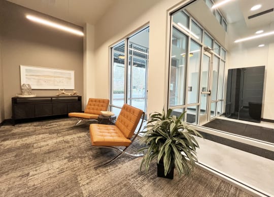 a room with two chairs and a table in front of a large window at The Duo, University Place, 98466