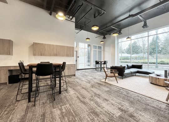 an open living room with a kitchen and dining area with a large window at The Duo, Washington