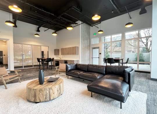 a living room with a leather couch and a coffee table at The Duo, University Place, WA 