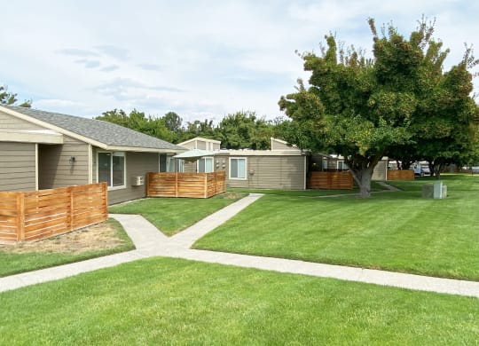 Green grass pathway leading to private homes at Park View Apartments in Wenatchee, WA