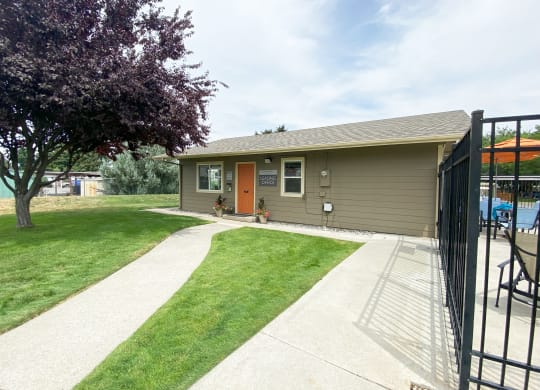 a home with a red door and a large tree in front of it at Park View Apartments, Washington