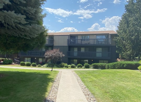 a large building with a brown roof and a sidewalk leading to it at Cedarwood, Washington, 98801