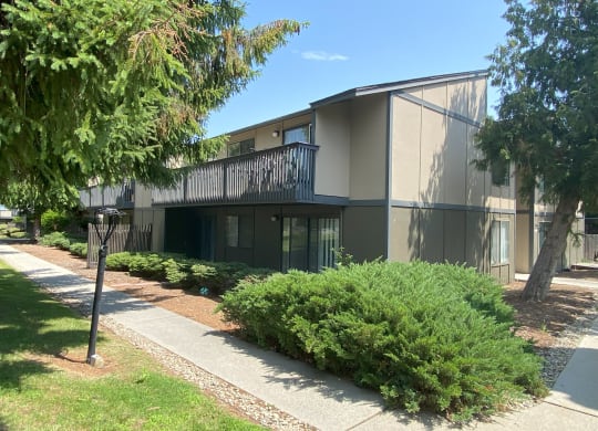 a building with a balcony and a sidewalk in front of it at Cedarwood, Washington