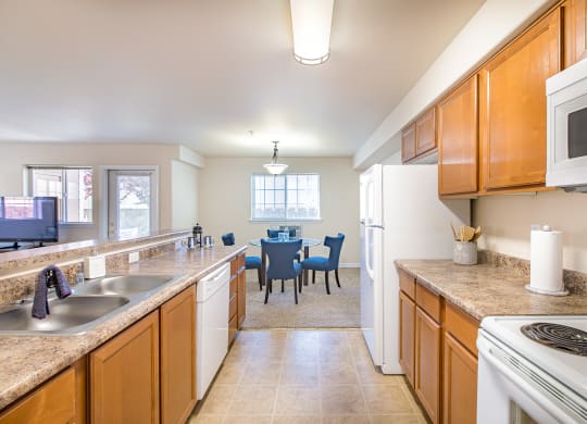 a kitchen and dining room with a table and a microwave  at Quail Springs, West Richland