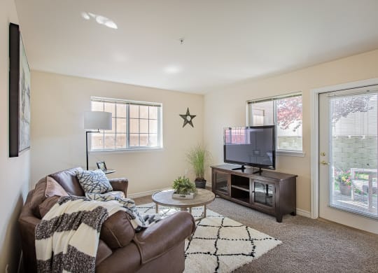 a living room with a couch and a tv  at Quail Springs, Washington, 99353
