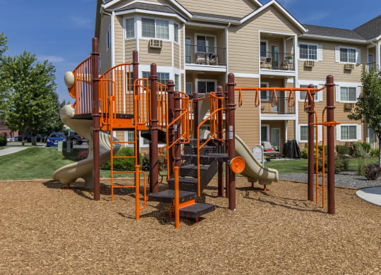 an orange playground in front of an apartment building  at Quail Springs, Washington, 99353