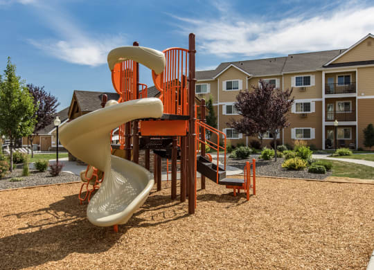 a playground with a slide at Quail Springs Apartments