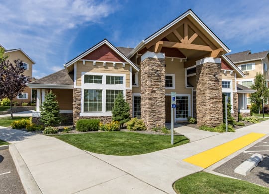 entry way with a sidewalk and green grass at Quail Springs Apartments