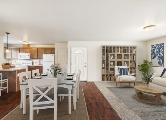 Open layout dining area looking into the kitchen. Wood-style flooring, light-filled windows, and kitchen bar seating. at Pine Tree Park, Washington, 99337