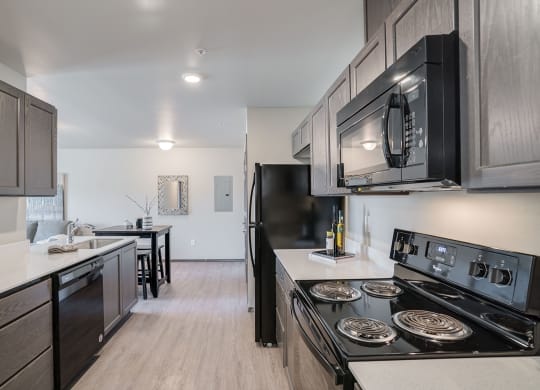 Kitchen looking into dining area. Hardwood floors and aisle style kitchen. at Altitude, East Wenatchee, WA, 98802