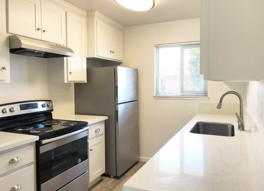 a kitchen with stainless steel appliances and a white counter top at Ella 1711 Apartments, Woodland, CA 95695