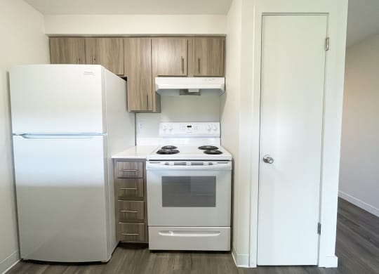 a kitchen with white appliances and a refrigerator and a stove  at The Trail, Snohomish, Washington