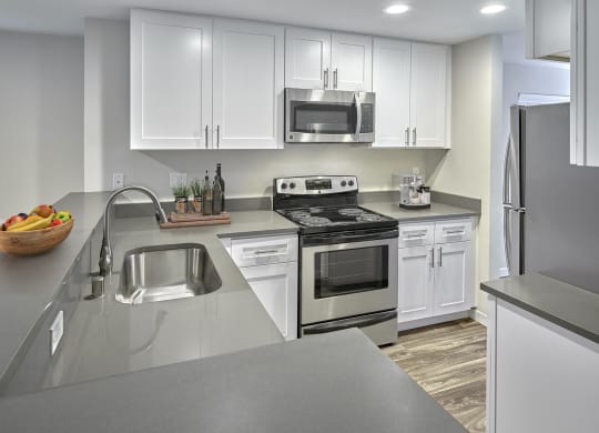 Updated kitchen with stainless steel appliances, white cabinets, and grey countertops.at Edmonds Gateway, Edmonds Washington