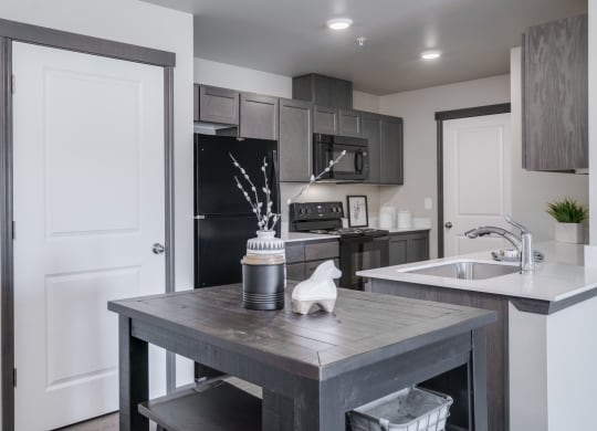 Dining area looking into Kitchen. Dining area has a small bar stool table and chairs. at Altitude, East Wenatchee, WA