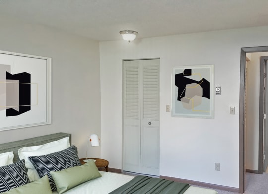 Bedroom corner with bed, closet, and door leading to the hallway and bathroom from left to right.at Laurel Park, Twin Falls, Idaho