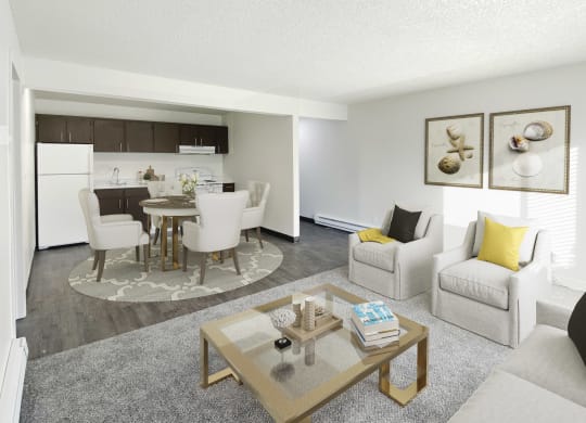 Living room opens into dining area and galley-style kitchen. Staged with dining set, 2 chairs, couch, coffee table.at Laurel Park, Twin Falls