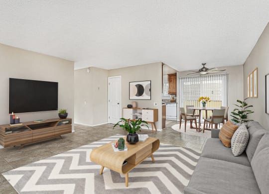 Apartment entrance leading into the living room with a large couch, coffee table and entertainment center with TV at Pacific Sands, San Diego, CA, 92117