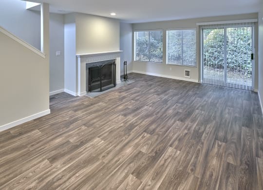 a living room with a fireplace and wooden floors at Edmonds Gateway, Edmonds Washington