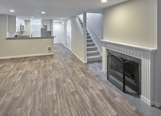 a living room with a fireplace and a staircase at Edmonds Gateway, Edmonds, 98026