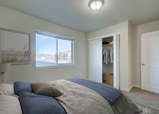 a bedroom with a bed and a closet and a window  at Madison Park, Bozeman, 59718