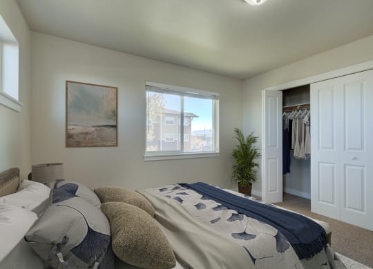a bedroom with a bed and a closet with a window  at Madison Park, Bozeman, 59718