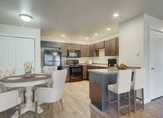 a kitchen and dining area with a table and chairs in a home at Madison Park, Bozeman, 59718