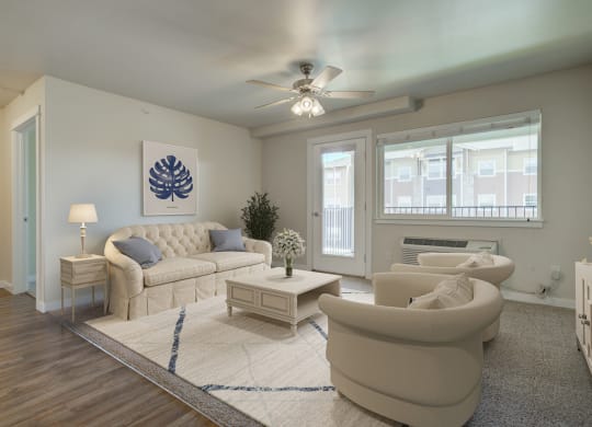 a living room with white furniture and a ceiling fan  at Madison Park, Bozeman, 59718