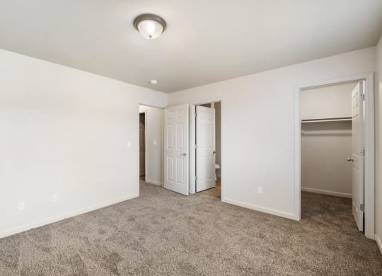 Clean, bright bedroom with taupe carpet, white walls and a large closet. at Pine Tree Park, Kennewick, 99337