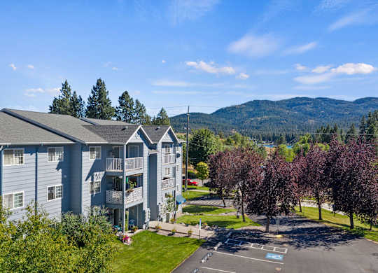 The Overlook Apartments in Post Falls featuring parking lot, building exteriors, and surrounding greenery.