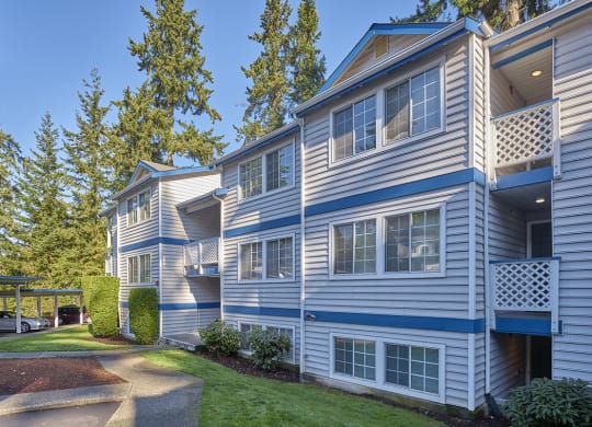 Exterior view of building with trees, manicured lawn and paved path.at Edmonds Gateway, Washington, 98026