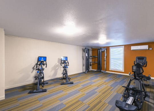 Fitness center with one window, stationary bikes, cable machine and rowing machine..at Park View Apartments, Wenatchee