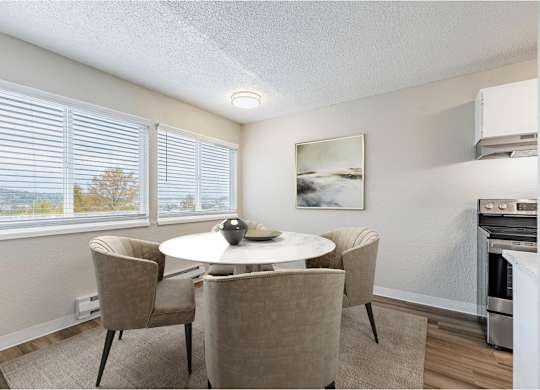 Dining area at Peak 88 Apartments in Renton, WA with table seating and open layout