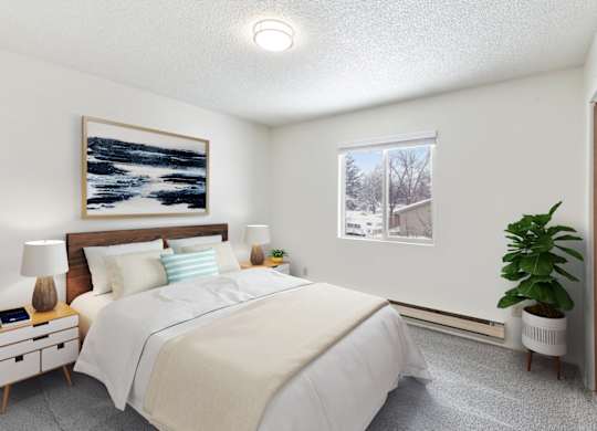 A bedroom with a large bed, a nightstand with a lamp, and a painting on the wall.